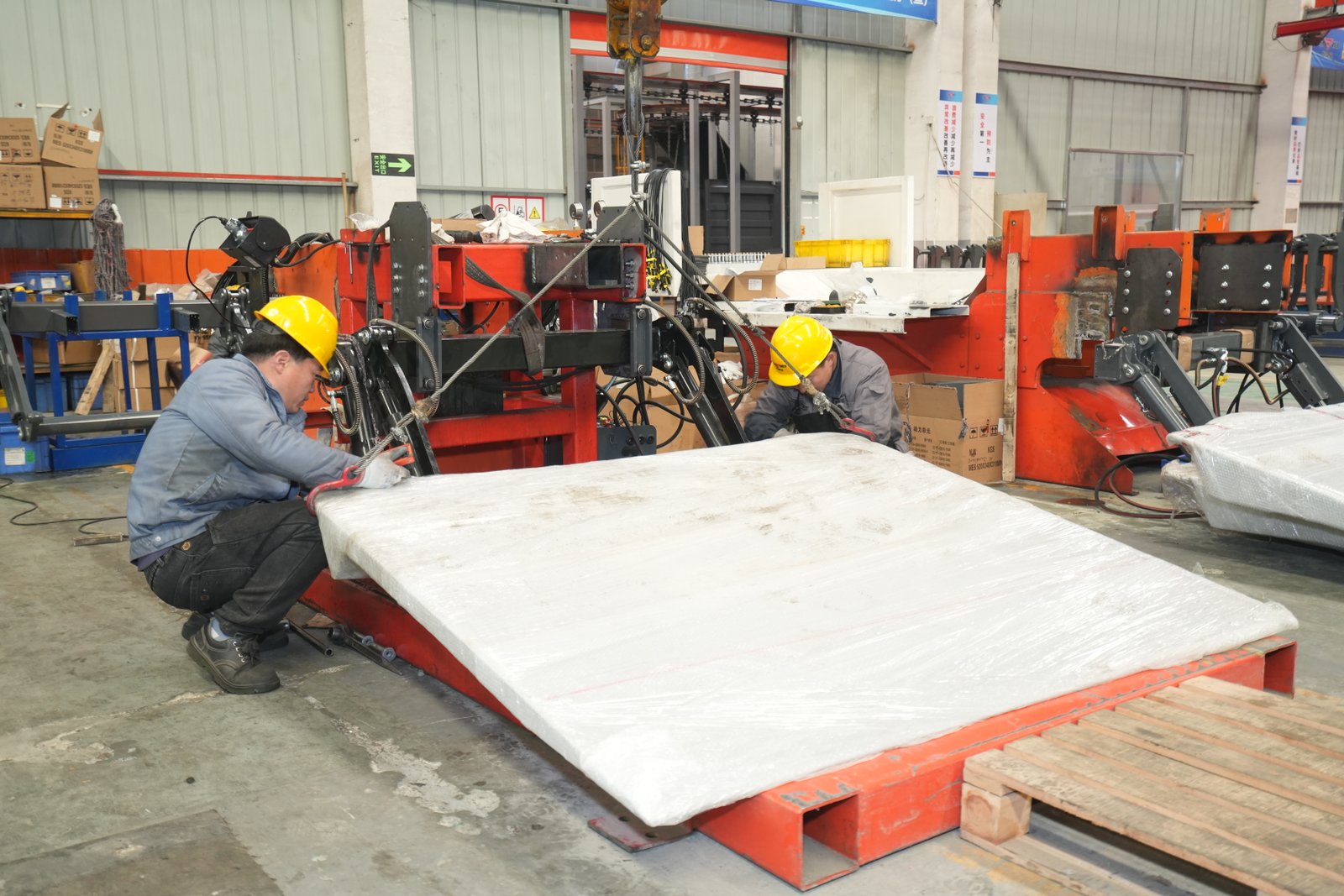 Professional installation of a Cadro folding hydraulic tail lift onto a commercial truck chassis at an authorized service center