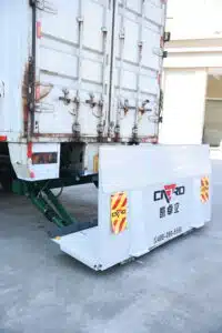 Refrigerated box truck at a loading dock with a hydraulic tail lift prepared for cold-chain cargo handling