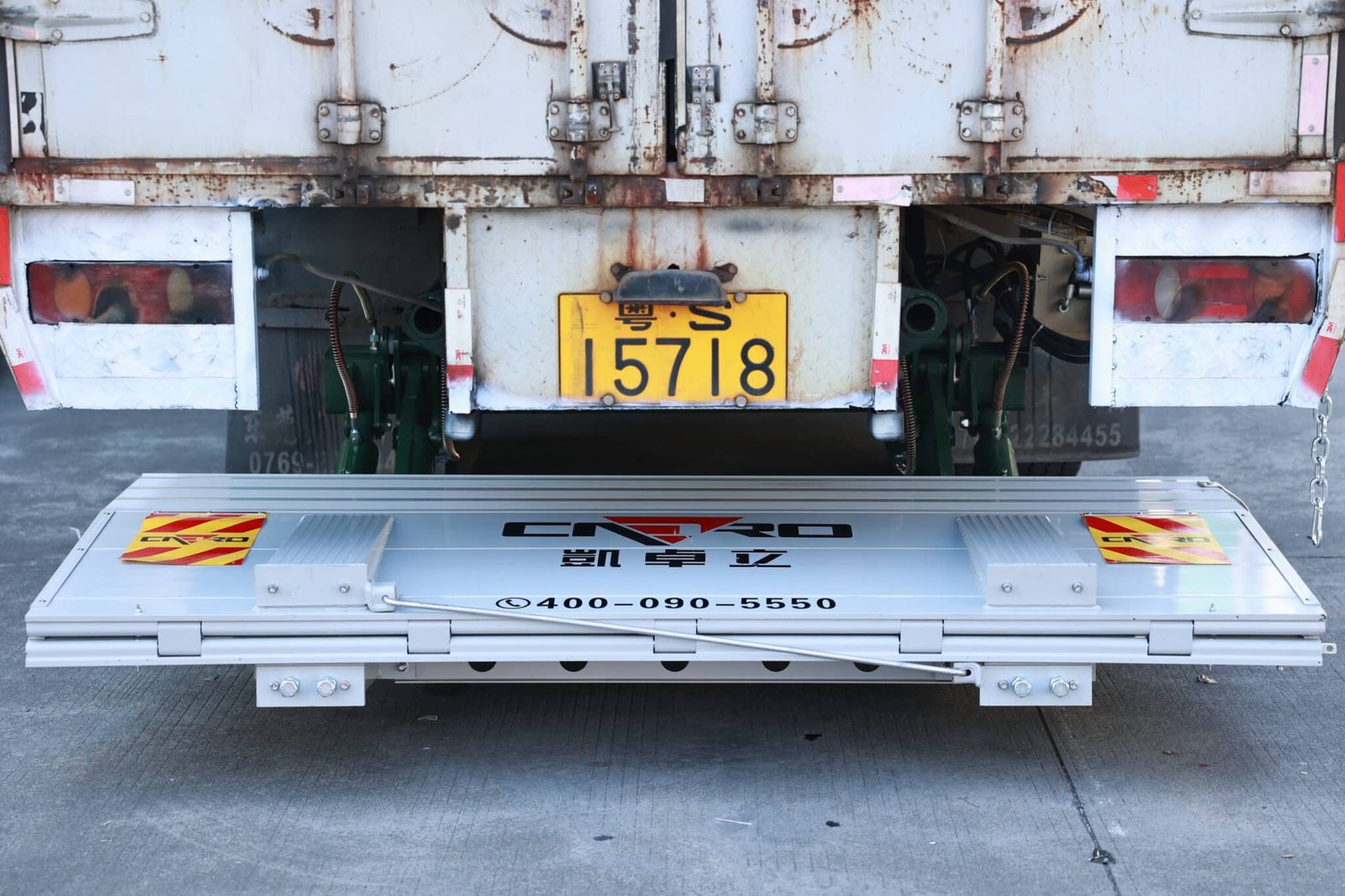 Tuckaway truck liftgate folded under a refrigerated truck body to keep the rear dock araea clear
