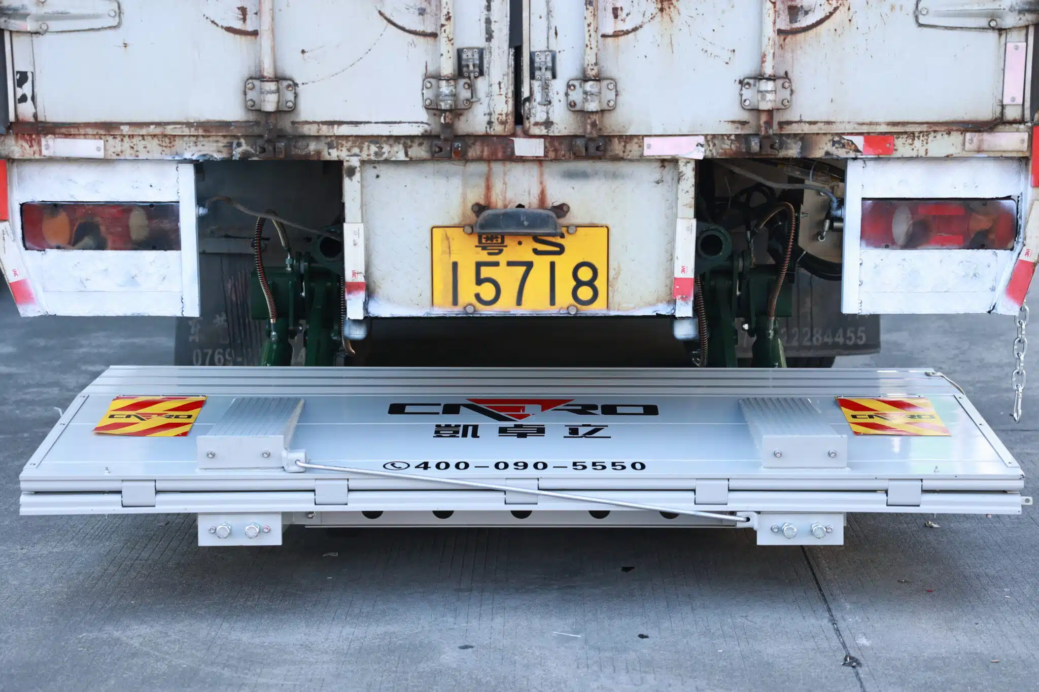Tuckaway truck liftgate folded under a refrigerated truck body to keep the rear dock araea clear