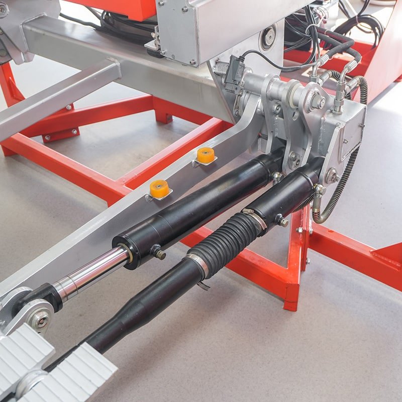 Close-up of Cadro hydraulic tail lift cylinders hinges and hose routing for certified installation checks